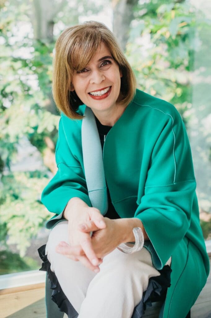 Lisa Kothari, telehealth counselor in New Jersey, Washington, and Maryland, smiles wearing green
